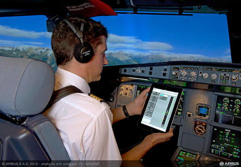 Pilot in the cockpit using flysmart app on tablet Pilot in the cockpit using flysmart app on tablet